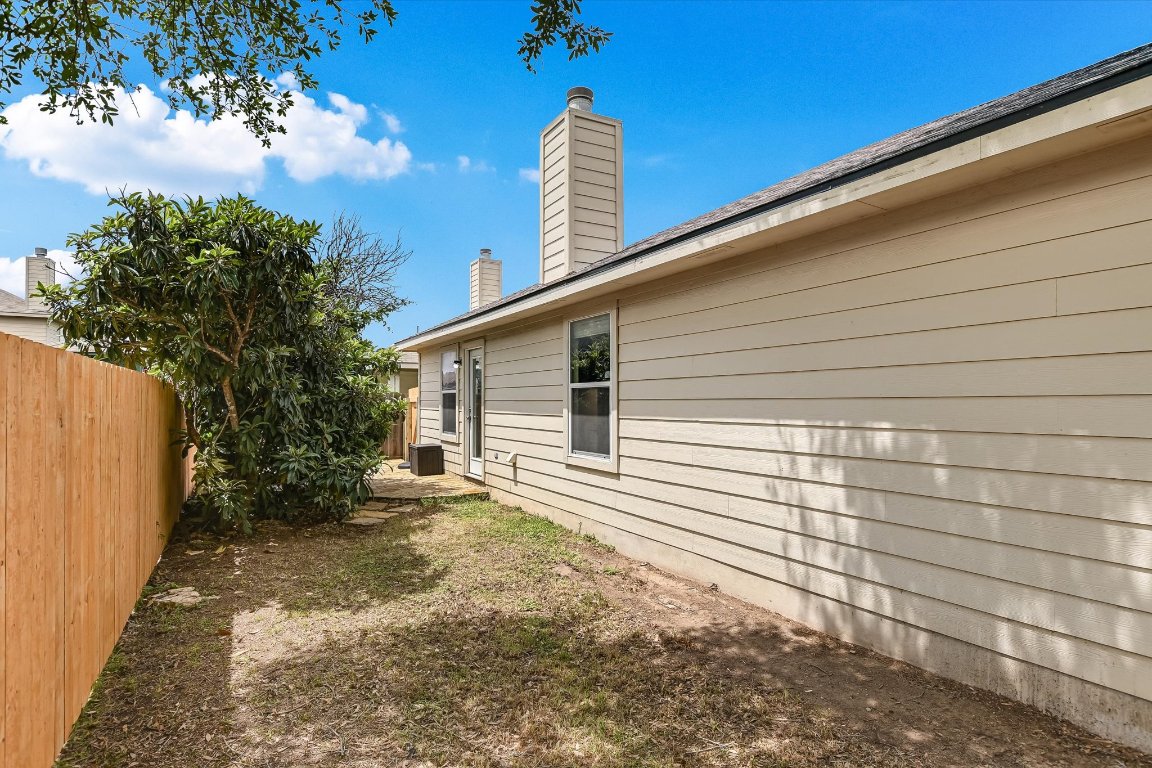 1901 Rachel Lane Round Rock, TX 78664 - Photo 35 of 35 View of side of home with fence and a chimney