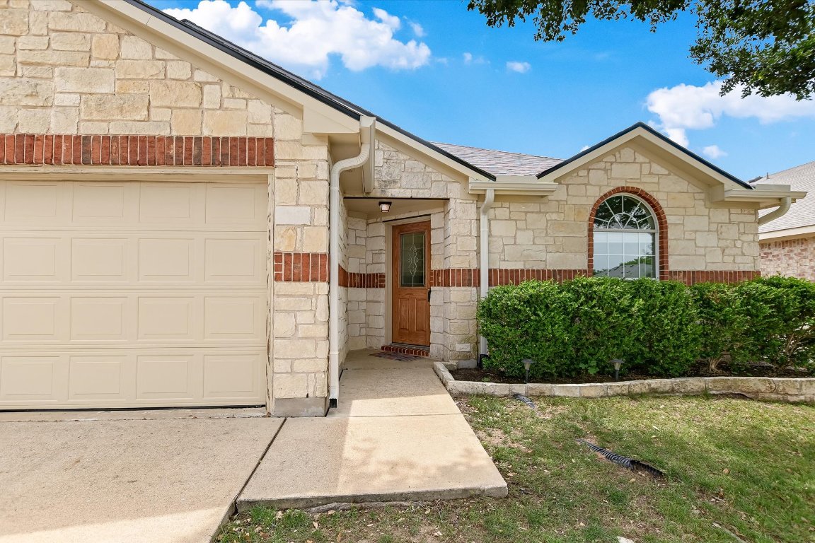 1901 Rachel Lane Round Rock, TX 78664 - Photo 4 of 35 View of front facade featuring stone siding and an attached garage