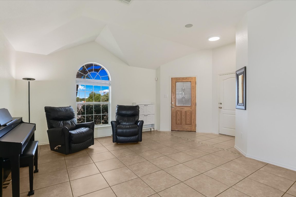 1901 Rachel Lane Round Rock, TX 78664 - Photo 10 of 35 Sitting room featuring vaulted ceiling and light tile patterned flooring