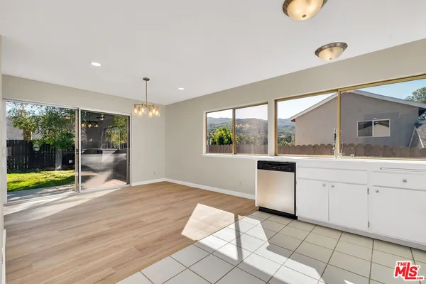 a kitchen with a sink stainless steel appliances and cabinets