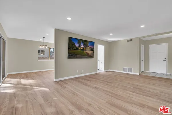 a bedroom with bed and wooden floor