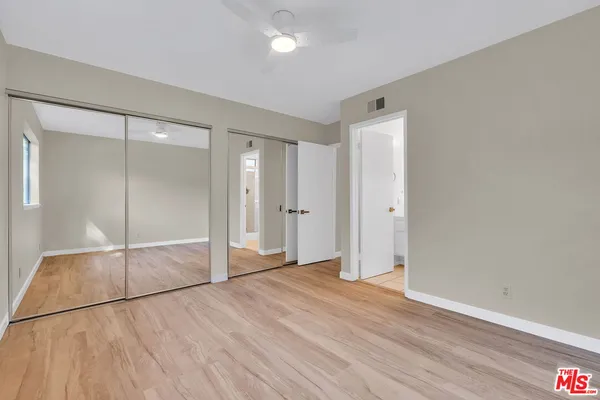 an empty room with wooden floor and a window
