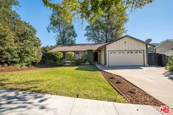 a view of a house with a yard