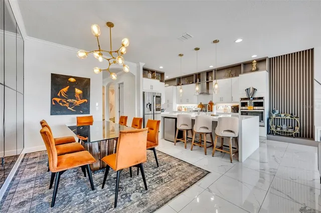 a living room with furniture kitchen view and a flat screen tv
