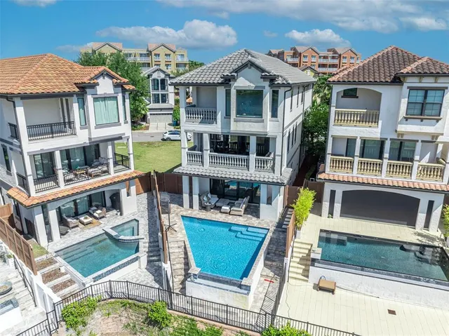 a kitchen with stainless steel appliances kitchen island granite countertop a table chairs microwave and sink