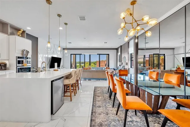 a view of a hallway with wooden floor and windows