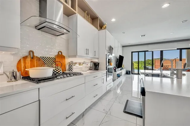 a spacious bathroom with a double vanity sink a mirror and a bathtub