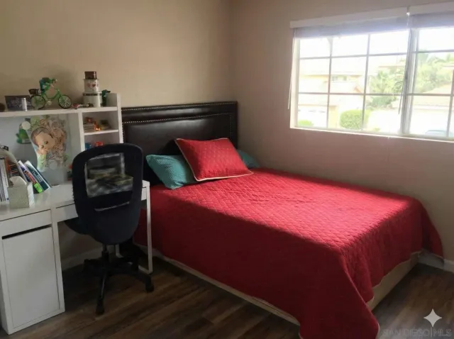 a bedroom with a bed and a window