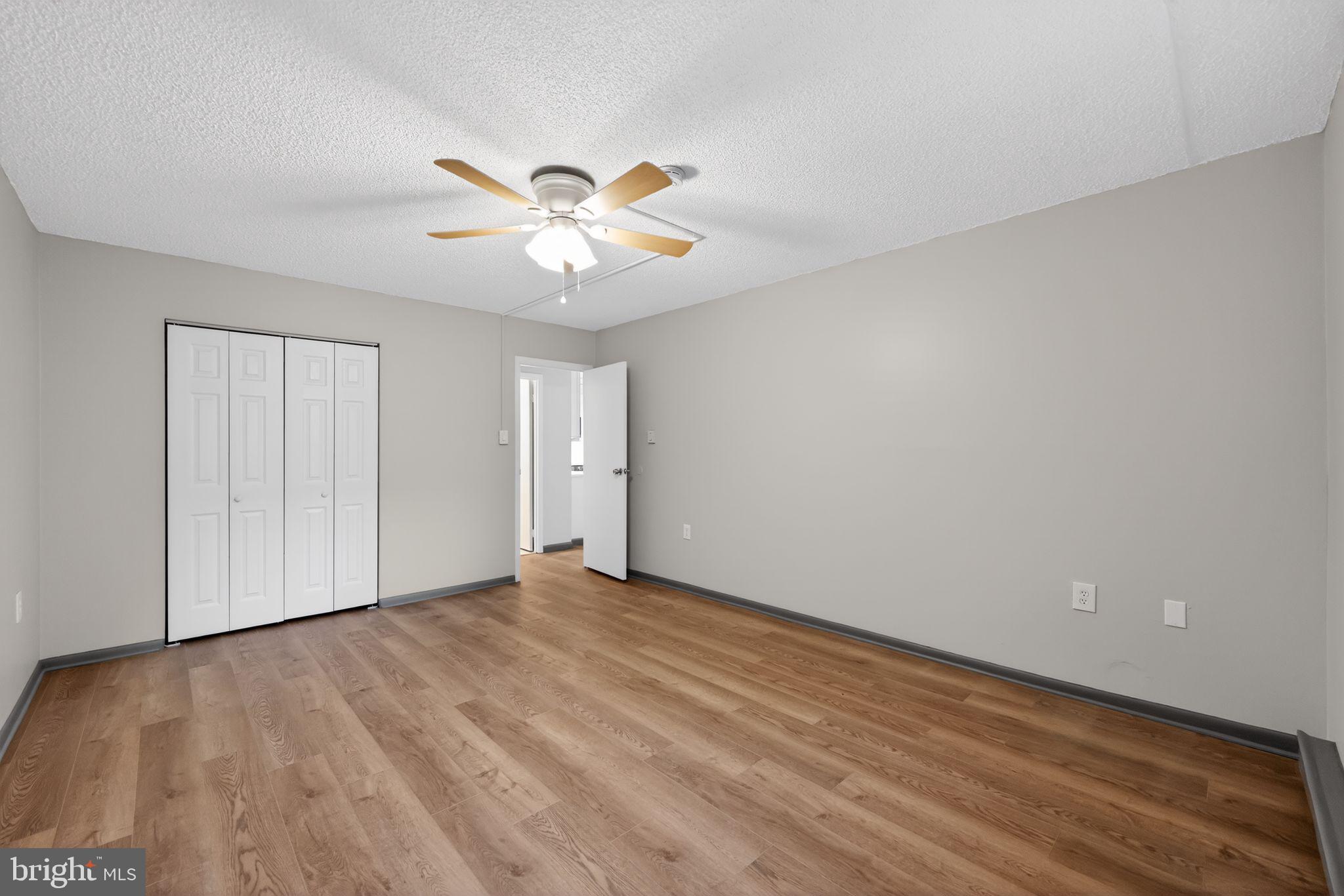 400 Glendale Road, Unit G33 Havertown, PA 19083 - Photo 13 of 26 a view of an empty room with chandelier fan and wooden floor