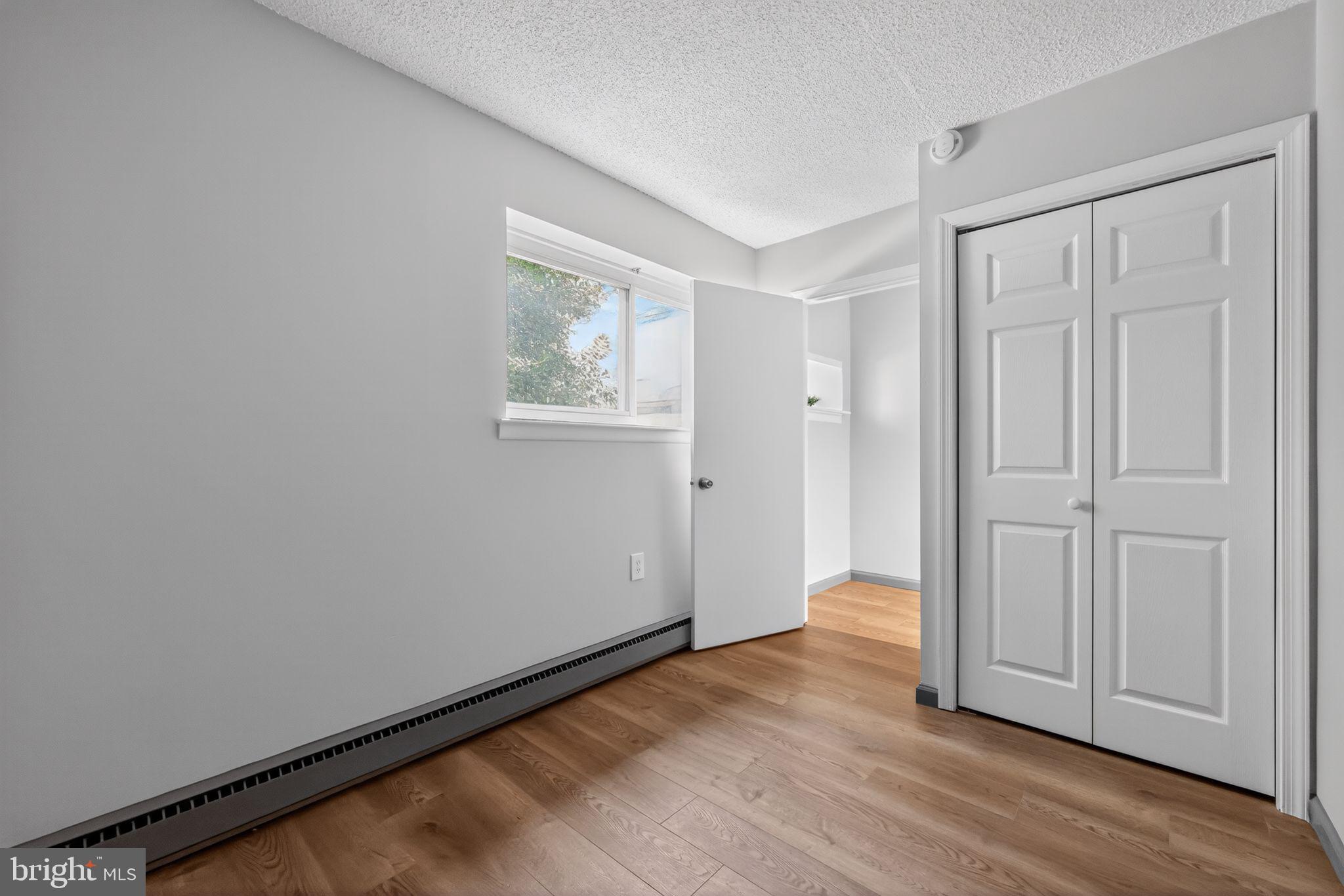 400 Glendale Road, Unit G33 Havertown, PA 19083 - Photo 14 of 26 an empty room with wooden floor and closet area