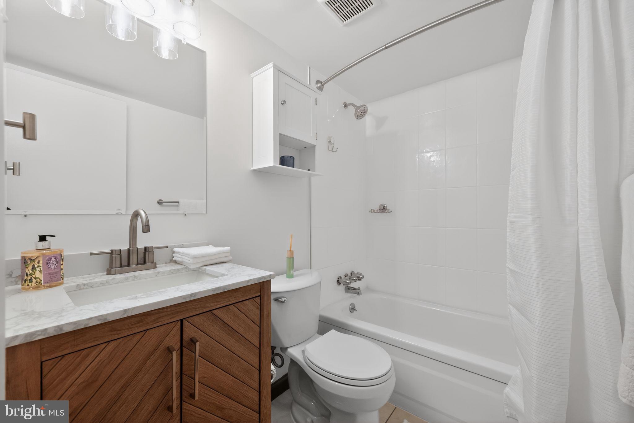 400 Glendale Road, Unit G33 Havertown, PA 19083 - Photo 16 of 26 a bathroom with a sink a toilet and a large mirror