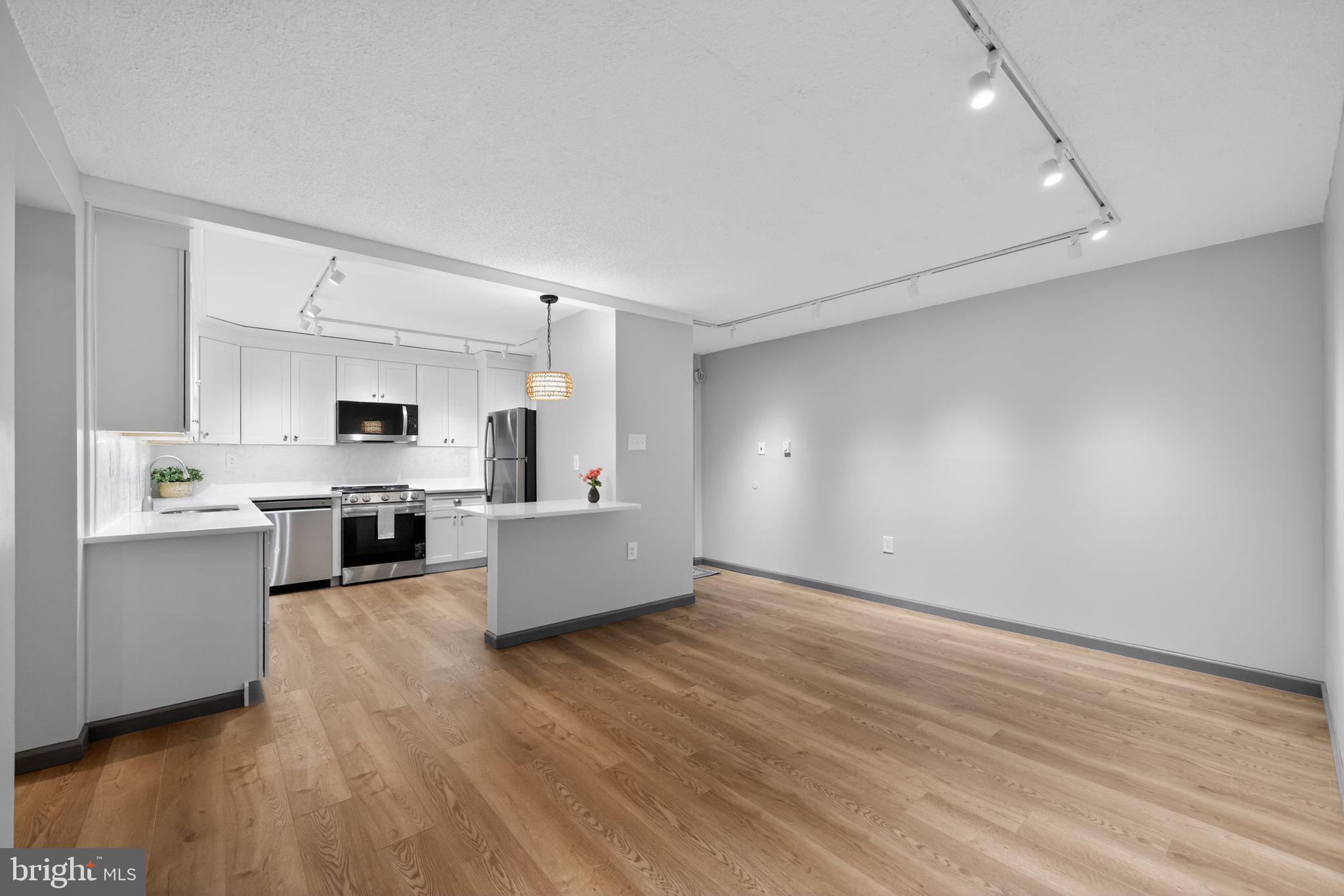 400 Glendale Road, Unit G33 Havertown, PA 19083 - Photo 3 of 26 a large white kitchen with a stove a sink dishwasher and a refrigerator with wooden floor