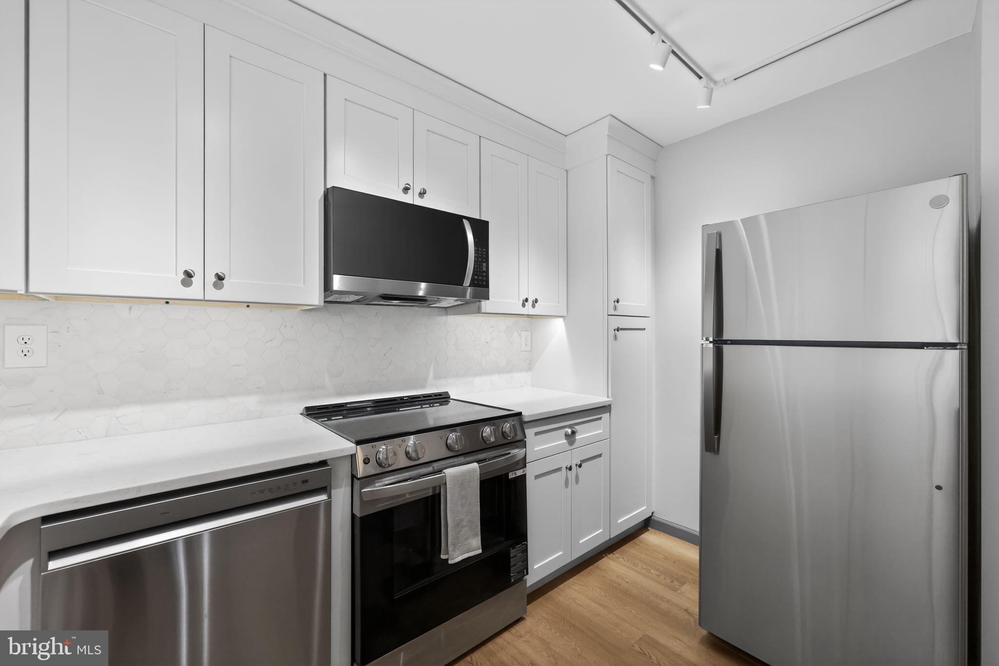 400 Glendale Road, Unit G33 Havertown, PA 19083 - Photo 6 of 26 a kitchen with stainless steel appliances a refrigerator stove and microwave
