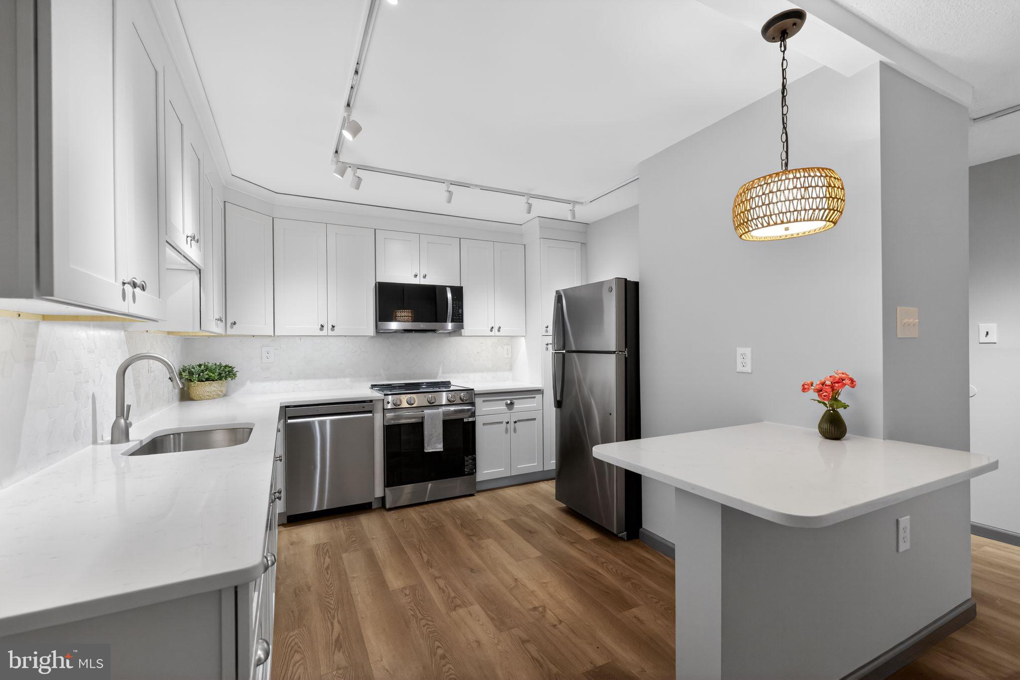 400 Glendale Road, Unit G33 Havertown, PA 19083 - Photo 8 of 26 a kitchen with stainless steel appliances a sink dishwasher a refrigerator a stove top oven a counter space and cabinets