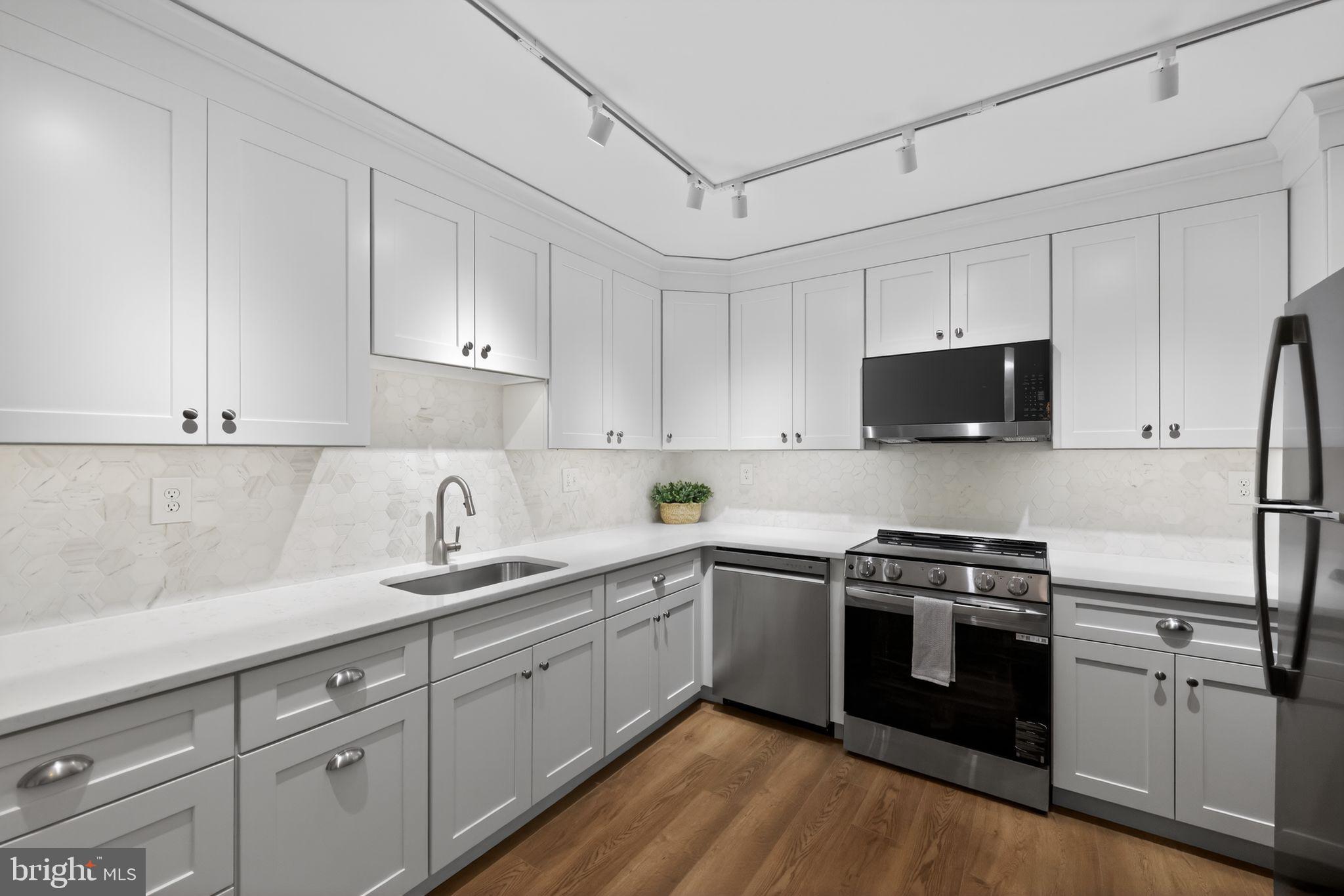 400 Glendale Road, Unit G33 Havertown, PA 19083 - Photo 10 of 26 a kitchen with stainless steel appliances granite countertop white cabinets a sink a stove a microwave and cabinetry