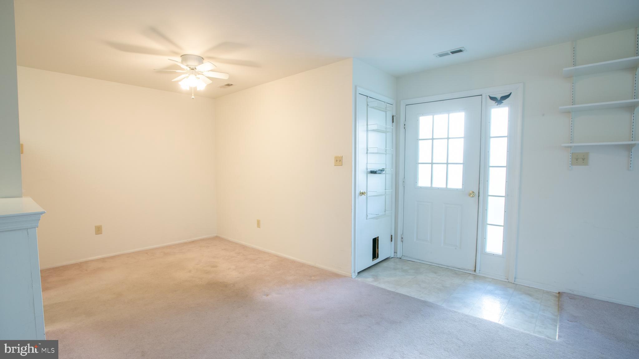 1403 Squirrel Road Marlton, NJ 08053 - Photo 4 of 21 an empty room with windows and chandelier fan