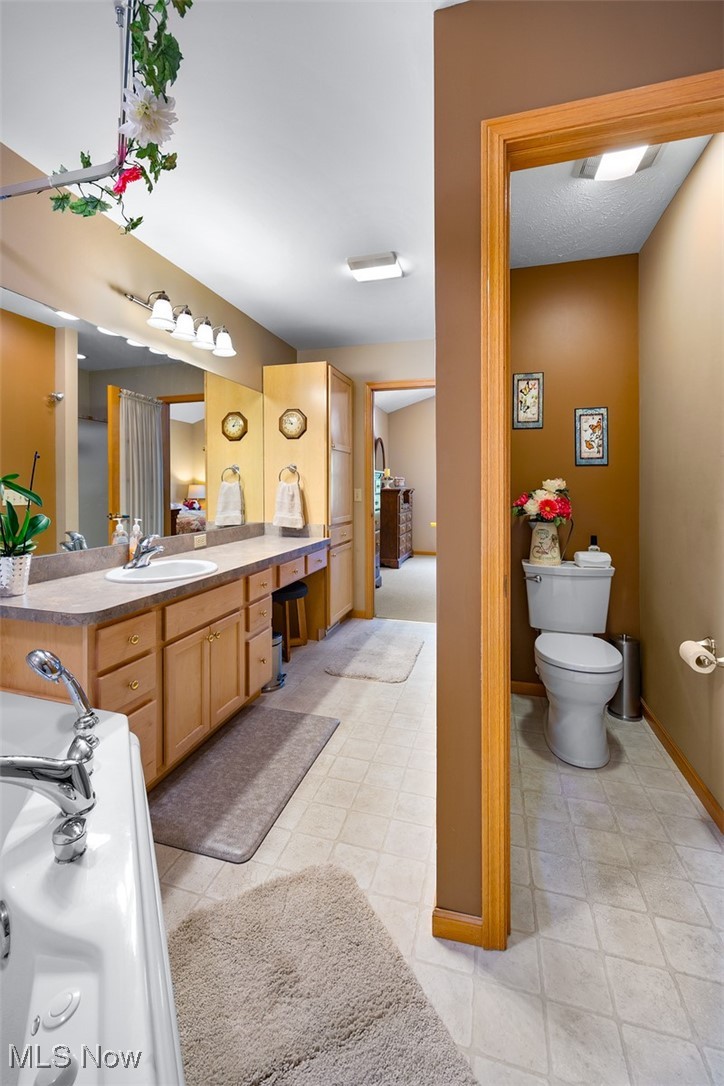1035 Parsons Road Grafton, OH 44044 - Photo 11 of 25 Bathroom with vanity, toilet, and tile patterned floors
