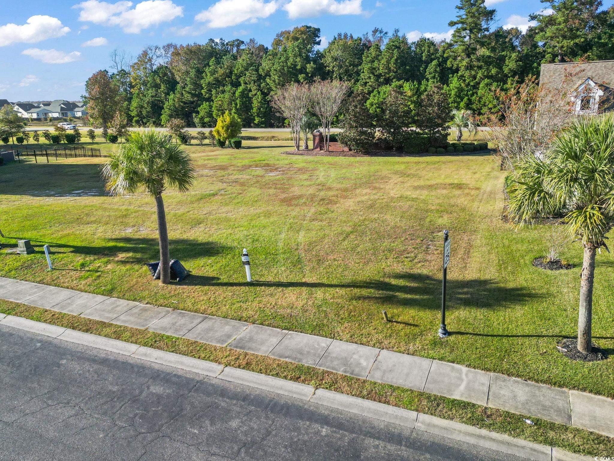 1103 East Isle Of Palms Avenue Myrtle Beach, SC 29579 - Photo 1 of 15 View of home's community featuring a lawn