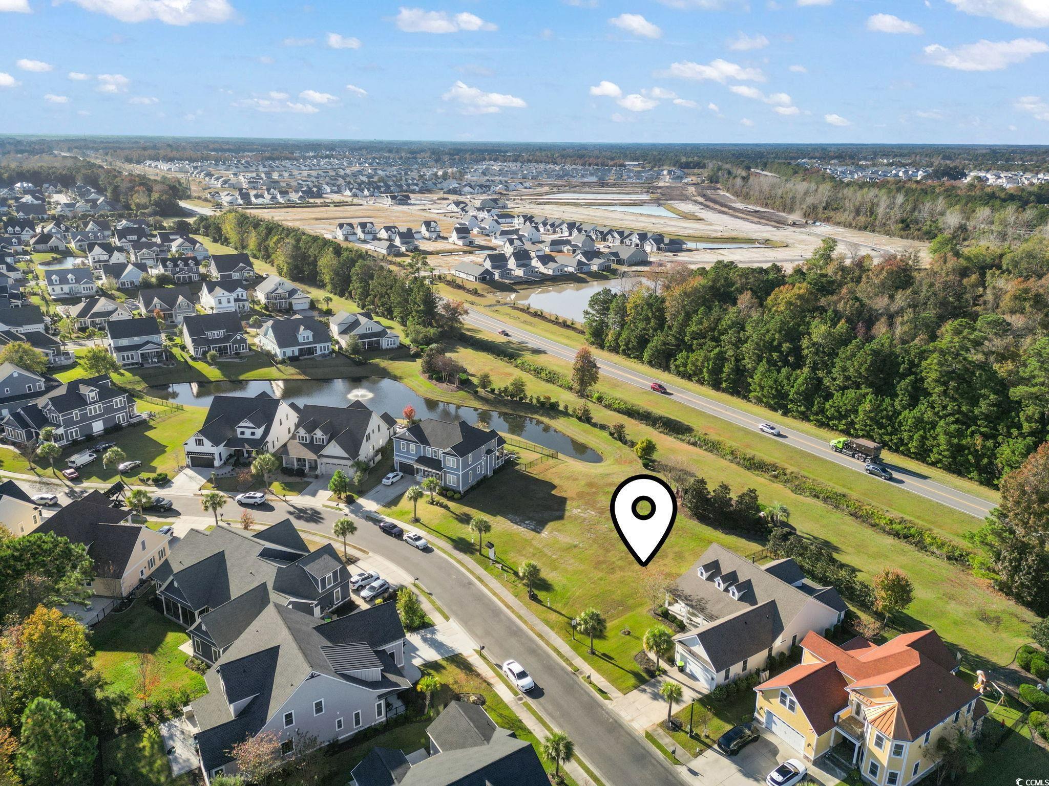 1103 East Isle Of Palms Avenue Myrtle Beach, SC 29579 - Photo 13 of 15 Aerial view of property and surrounding area featuring a nearby body of water and nearby suburban area