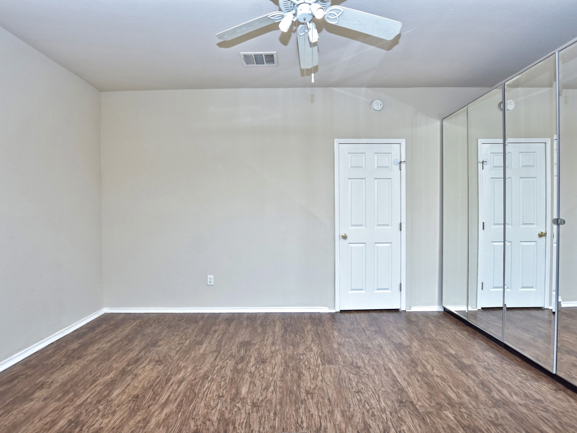 917 East 3rd Street Georgetown, TX 78626 - Photo 11 of 23 Reflective mirrored closet doors create an illusion of spaciousness in this inviting room.