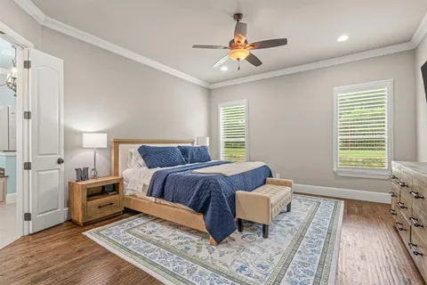 a spacious bedroom with a bed and a chandelier