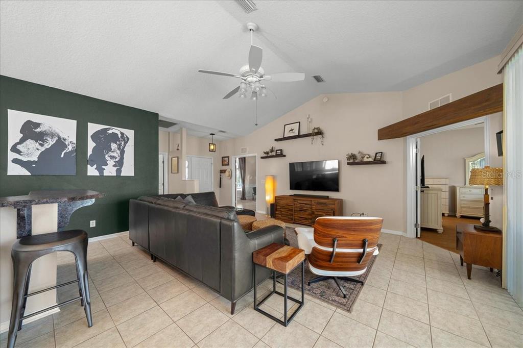 2197 Northwest 55th Avenue Road Ocala, FL 34482 - Photo 22 of 66 a living room with furniture and a flat screen tv