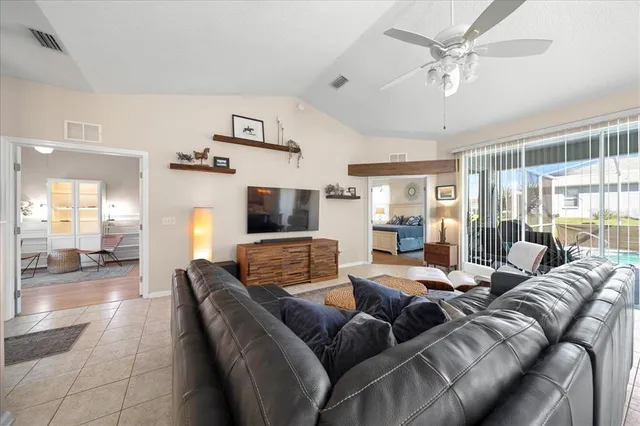 a bedroom with a bed and a chandelier fan