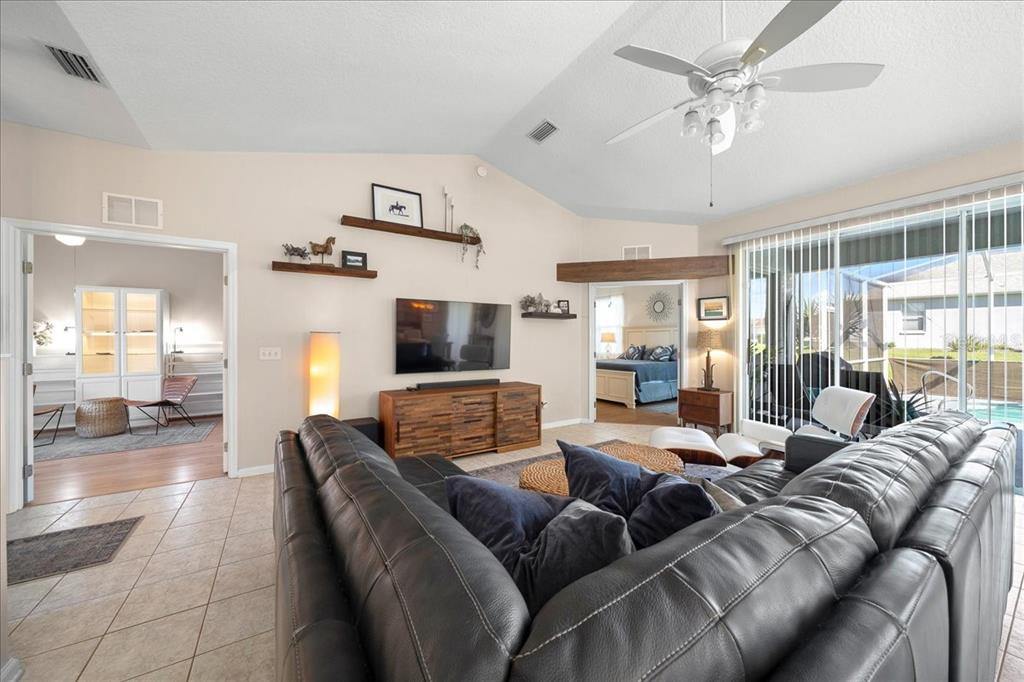 2197 Northwest 55th Avenue Road Ocala, FL 34482 - Photo 24 of 66 a living room with furniture and a flat screen tv