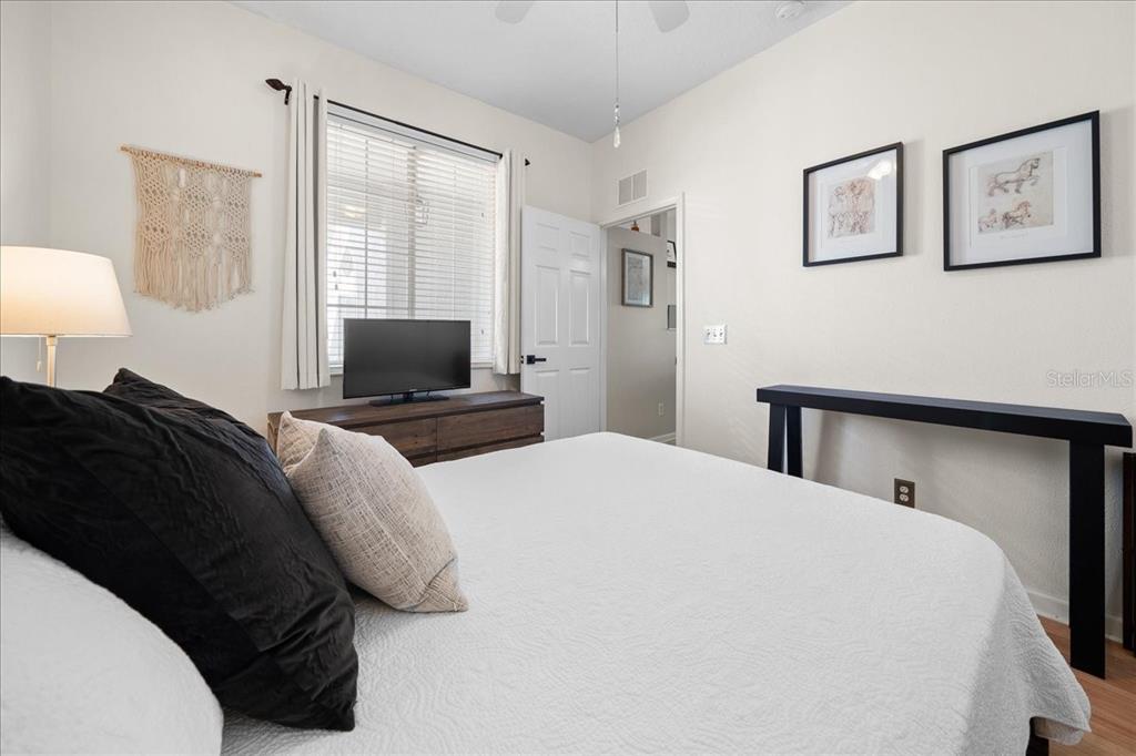 2197 Northwest 55th Avenue Road Ocala, FL 34482 - Photo 28 of 66 a bedroom with a bed and wooden floor