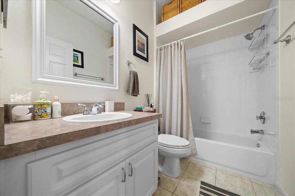 2197 Northwest 55th Avenue Road Ocala, FL 34482 - Photo 30 of 66 a bathroom with a granite countertop sink a toilet and a bathtub