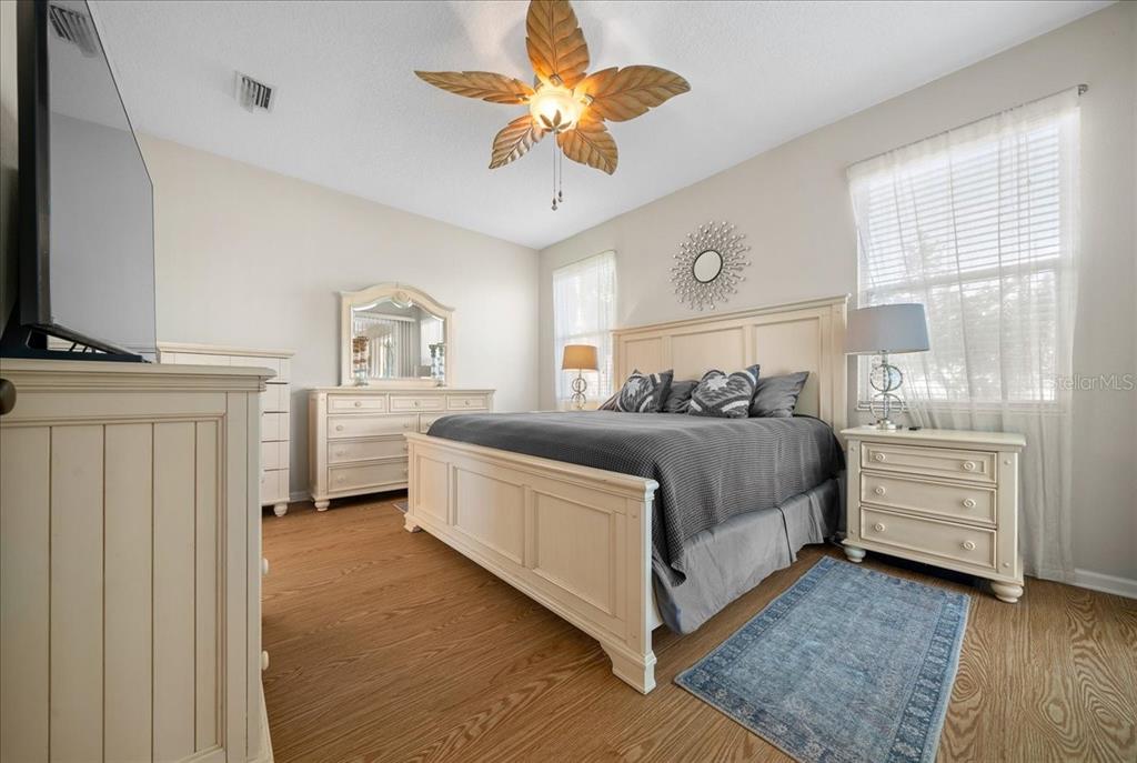 2197 Northwest 55th Avenue Road Ocala, FL 34482 - Photo 31 of 66 a bedroom with a bed and a chandelier fan