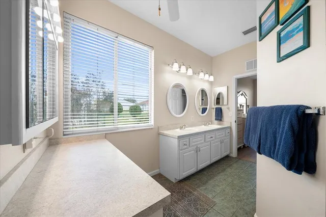 a kitchen with stainless steel appliances granite countertop a refrigerator a sink a stove and microwave