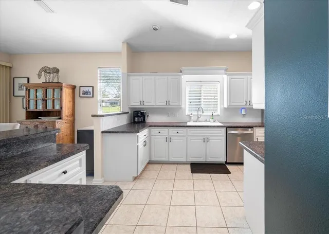 an aerial view of ocean and residential houses with outdoor space