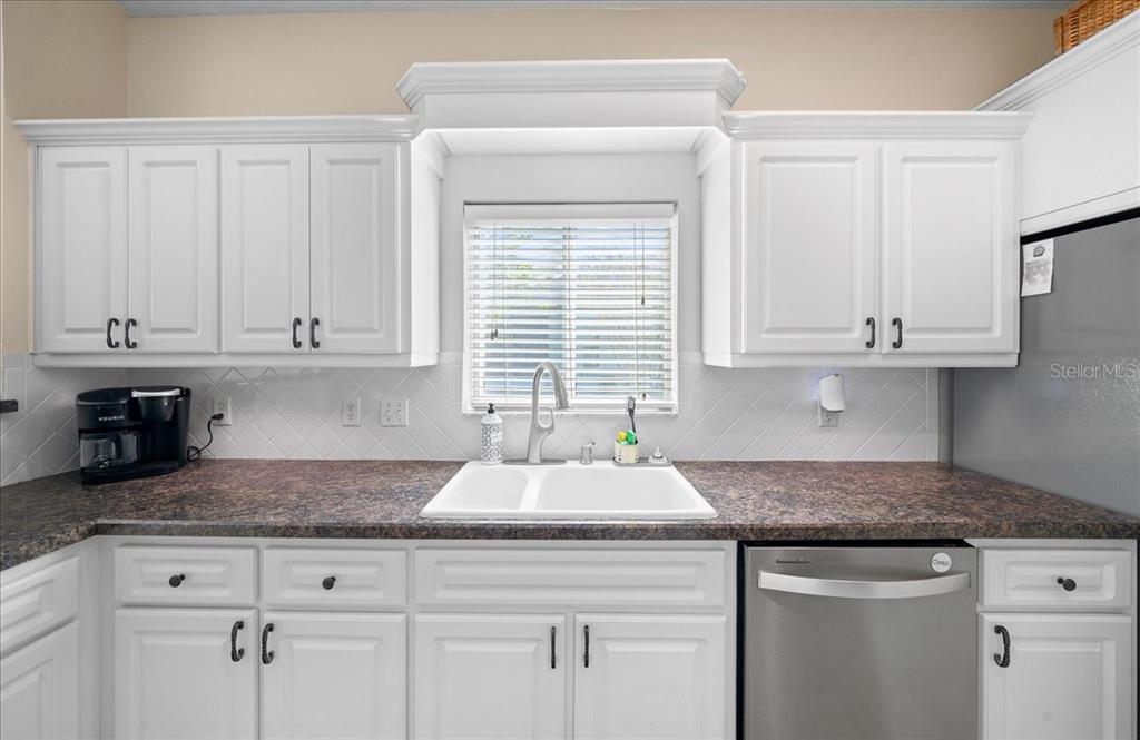 2197 Northwest 55th Avenue Road Ocala, FL 34482 - Photo 47 of 66 a kitchen with granite countertop white cabinets and a window