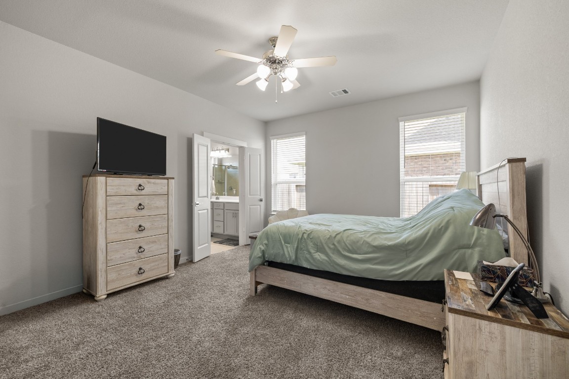 1217 Red Hills Drive Rosharon, TX 77583 - Photo 11 of 25 a spacious bedroom with a bed and a flat tv screen on dresser