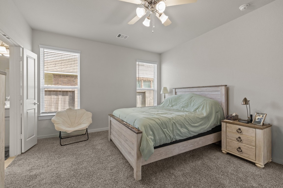 1217 Red Hills Drive Rosharon, TX 77583 - Photo 12 of 25 a spacious bedroom with a bed and a chair