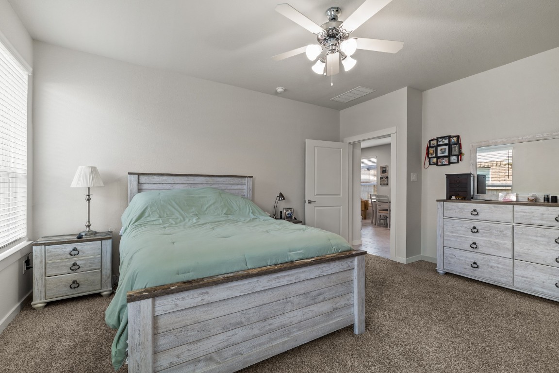 1217 Red Hills Drive Rosharon, TX 77583 - Photo 13 of 25 a bedroom with a bed and a chandelier