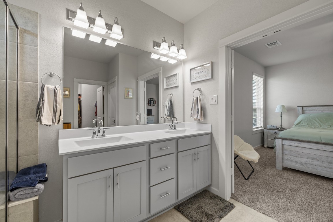 1217 Red Hills Drive Rosharon, TX 77583 - Photo 16 of 25 a bathroom with a double vanity sink and a mirror