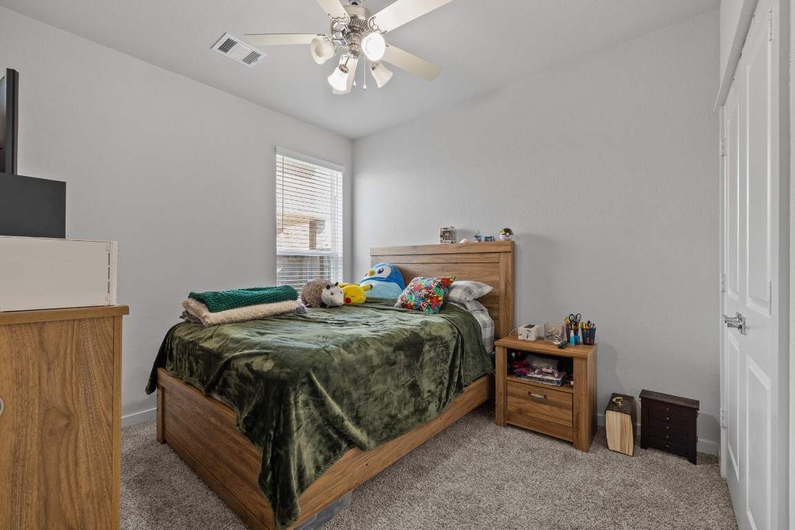 1217 Red Hills Drive Rosharon, TX 77583 - Photo 17 of 25 a bedroom with a bed and a chandelier