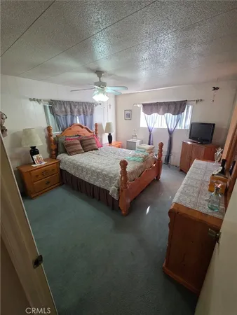a bedroom with bed and window