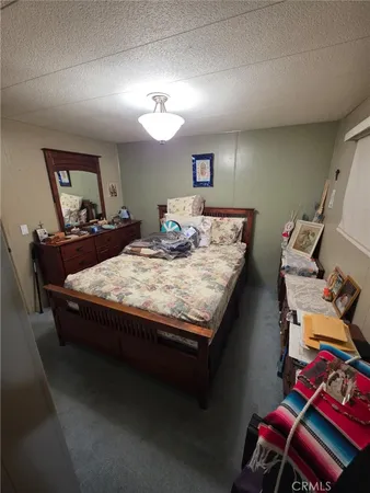 a bed sitting in a room next to a window