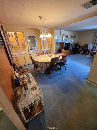 a living room with furniture and a dining table