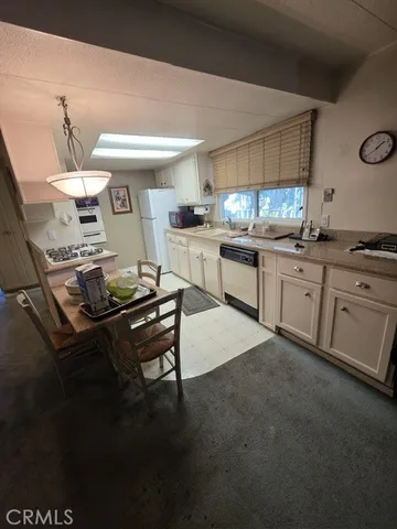 a kitchen with a sink appliances and cabinets