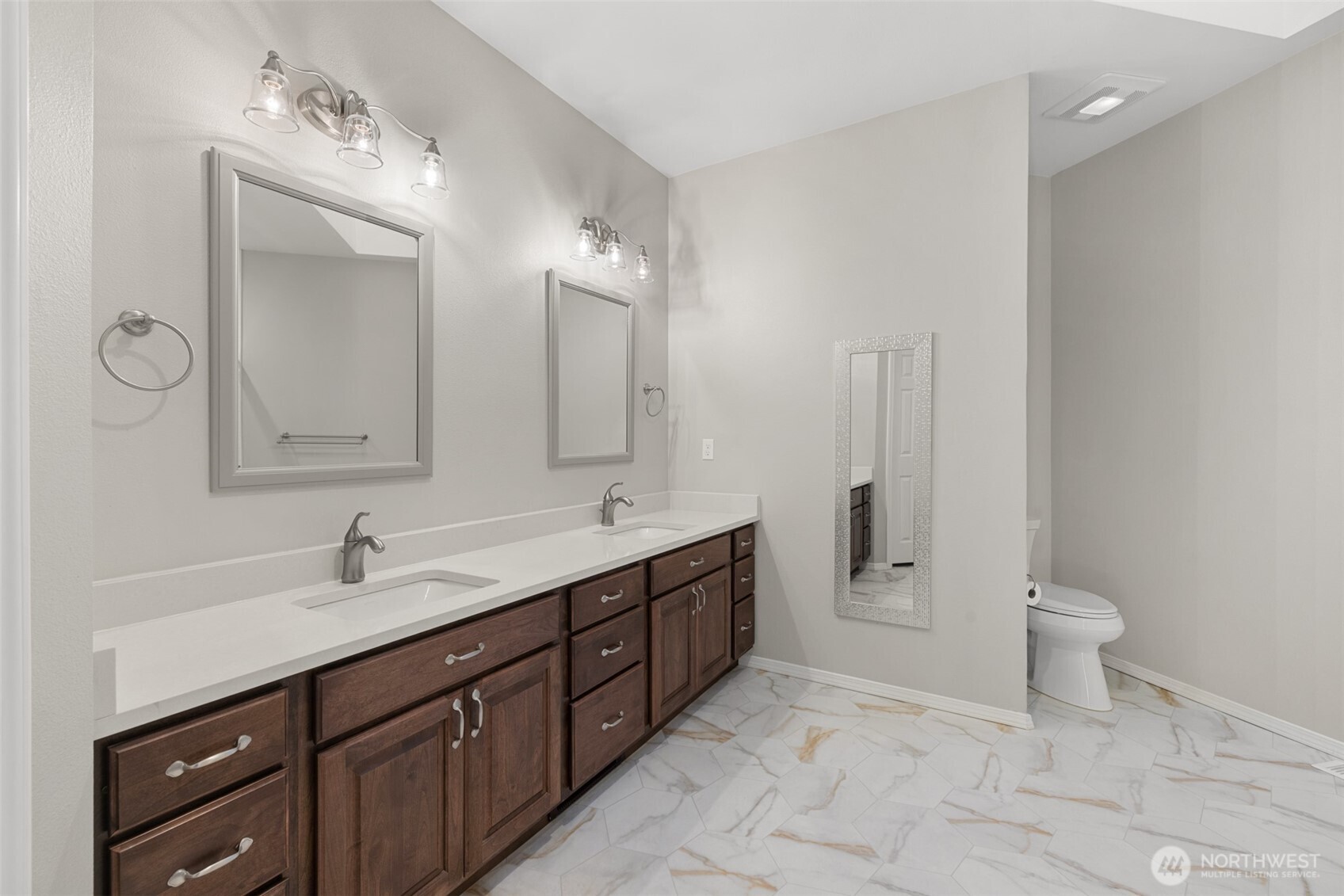 191 Cascadia Loop Sequim, WA 98382 - Photo 12 of 40 a spacious bathroom with a double vanity sink a toilet and a mirror