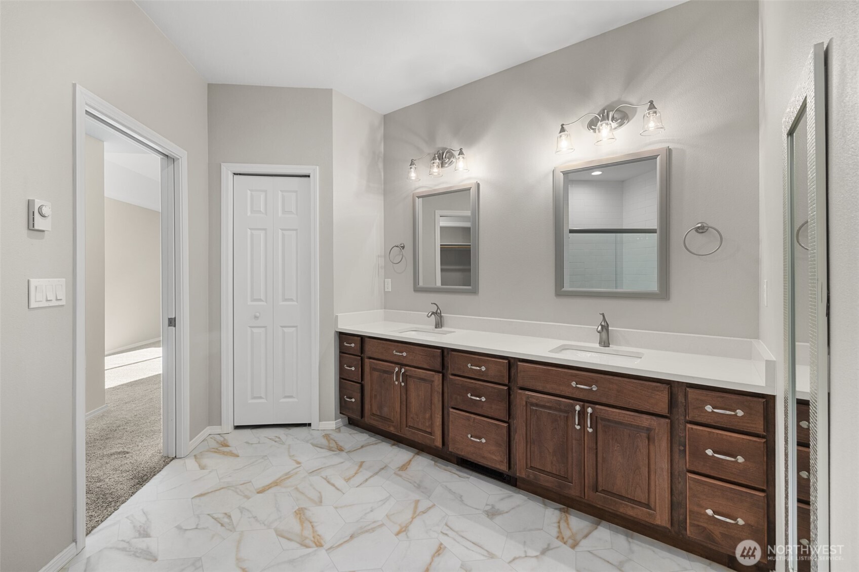 191 Cascadia Loop Sequim, WA 98382 - Photo 14 of 40 a spacious bathroom with a granite countertop sink a mirror and a