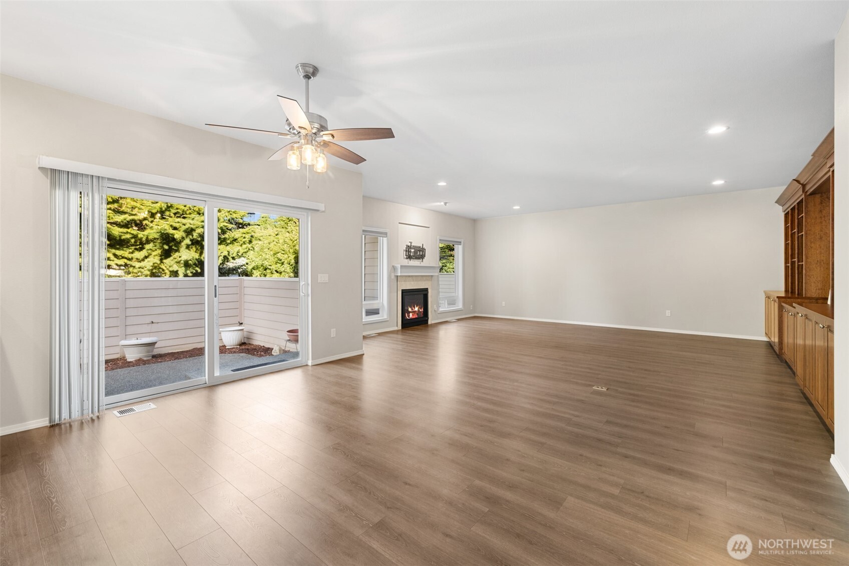 191 Cascadia Loop Sequim, WA 98382 - Photo 17 of 40 a view of an empty room with wooden floor and a window