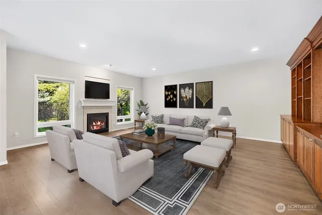 a living room with furniture a fireplace and a flat screen tv