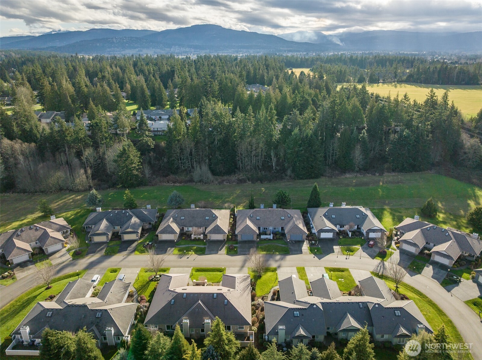191 Cascadia Loop Sequim, WA 98382 - Photo 2 of 40 a view of a house with pool and a garden