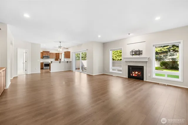 a view of a living room with furniture and a fireplace