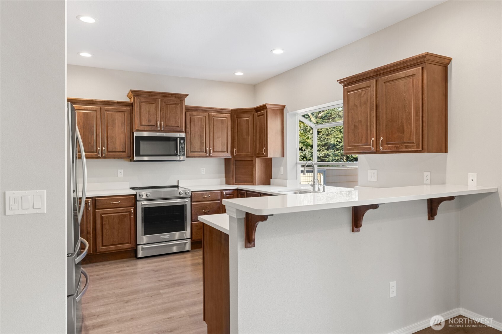 191 Cascadia Loop Sequim, WA 98382 - Photo 27 of 40 a kitchen with stainless steel appliances a sink stove and microwave